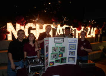 Lab members pose in front of "Night at the Zach" lights